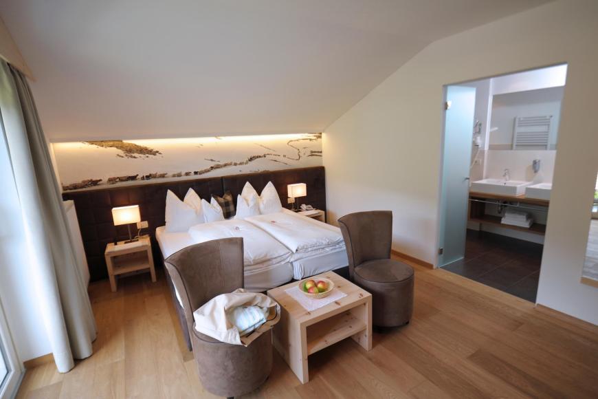 Double room South+ Zirm with two armchairs
